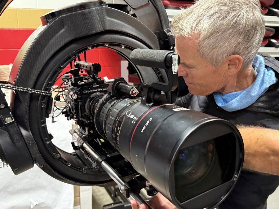 Crew member framing a shot on a cinema camera rig